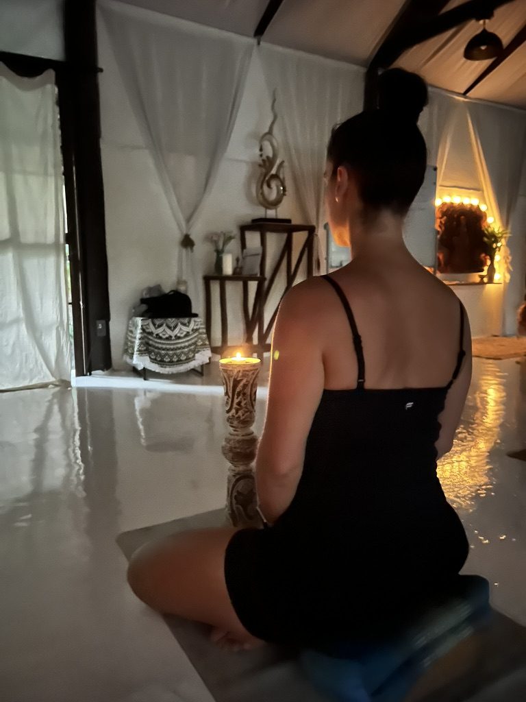 Cristal meditating by candlelight